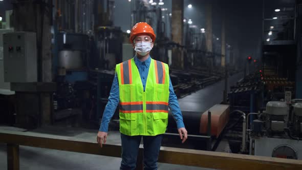 Masked Engineer Crossing Hands Wearing Face Mask at Modern Special Factory