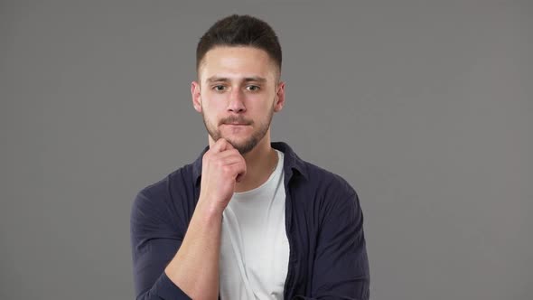 Portrait of Smart Guy in Casual Clothing Posing with Doubting Brooding Look While Thinking or