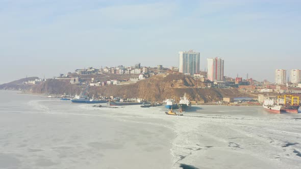 The Piers of the Peninsula with Moored Ships and the Icecovered Sea