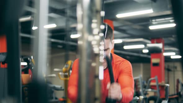 Fitness Machine Is Being Used By a Man To Build His Arms