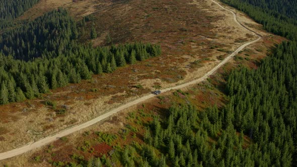 Aerial Car on Mountain Road View Going to Camp Among Green Rocky Trees Growing