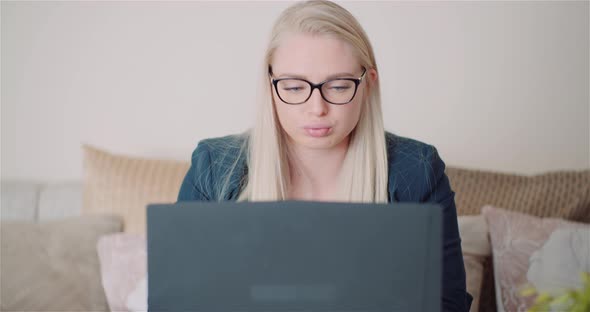 Female Entrepreneur Using Laptop In Office