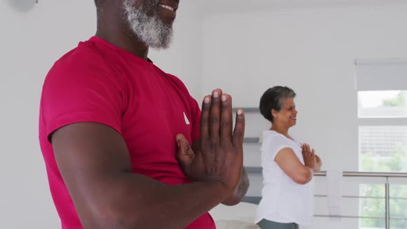 Diverse group of seniors taking part in fitness class at home