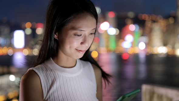 Woman use of mobile phone at night