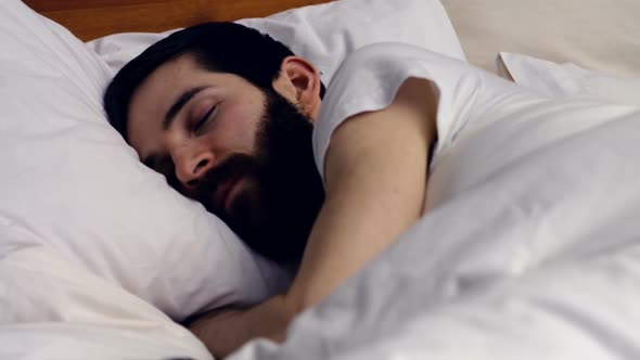 Couple sleeping on bed in bedroom