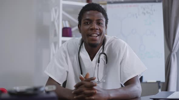 Confident Positive African American Doctor Talking in Video Chat Front View