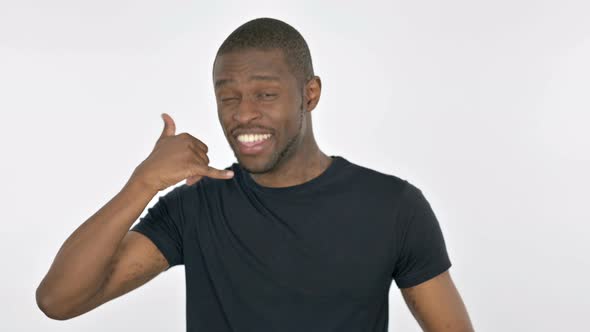 Call Me Gesture By Young African Man on White Background