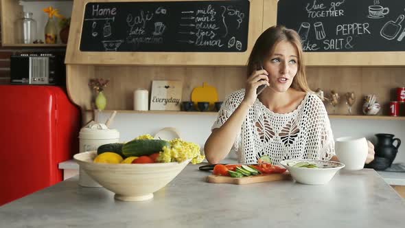 Woman Having Coffee As Talking on Phone