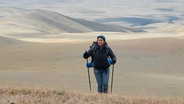 Young Caucasian Woman Climbing on a Mountain Hill