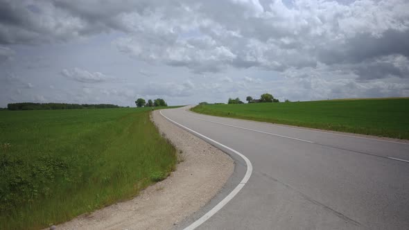 Crossroad of Dirt and Asphalt Road in Summer