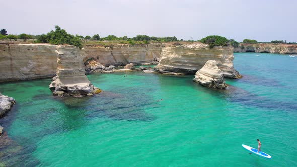 4K aerial of the rock formations of Sant'Andrea near Torre Dell'Orso, Apulia, Italy in the summer.