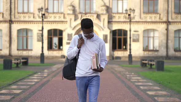 Confident Intelligent African American Student Walking in Slow Motion at University Campus Outdoors