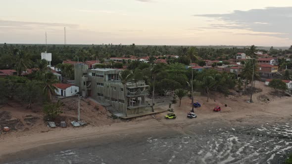 Small Guriu hotel resort at famous kite surf spot in Brazil; drone parallax