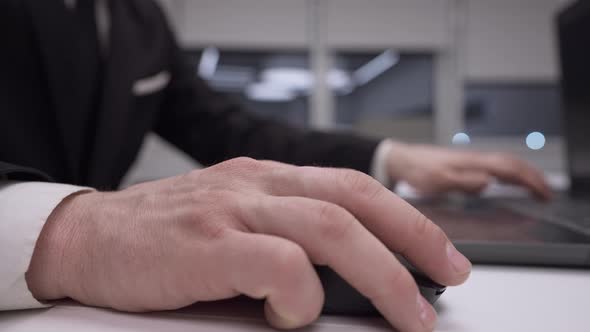 Closeup Male Caucasian Hand Using Computer Mouse in Office in Slow Motion