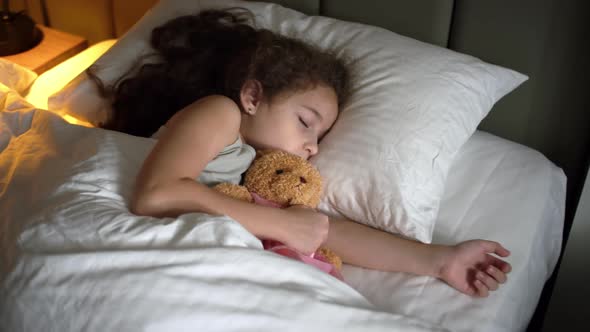 Child Little Baby Girl Sleeps Sweetly in His Crib and Smiles in His Sleep