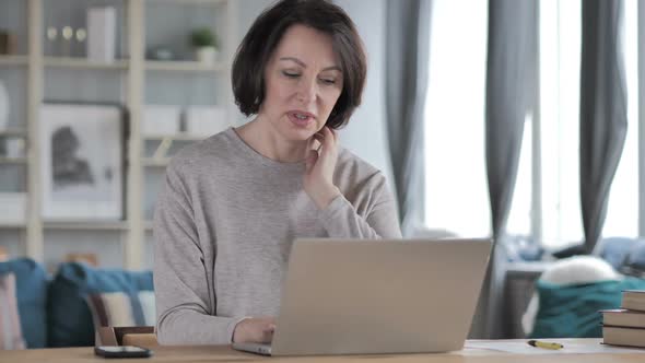 Old Senior Woman with Neck Pain Working on Laptop