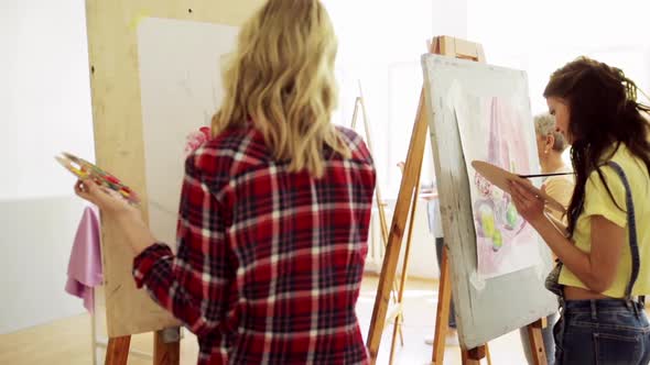 Students with Easels Painting at Art School