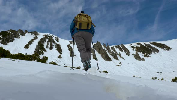 Young Woman with a Backpack Travels in the Mountains