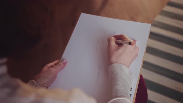Woman Artist Sketching on White Paper.