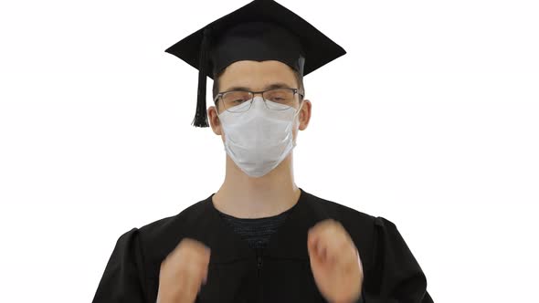 Young Man with Graduation Gown in Medical Mask on White Background