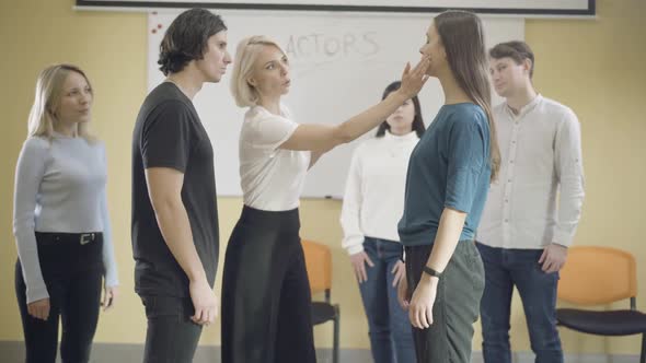 Group of Male and Female Actors Studying in Auditorium