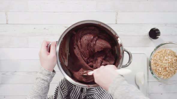 Flat lay. Step by step. Melting chocolate chips in the cooking pot to make macadamia nut fudge.