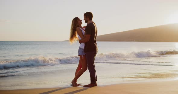 Attractive couple kissing on the beach