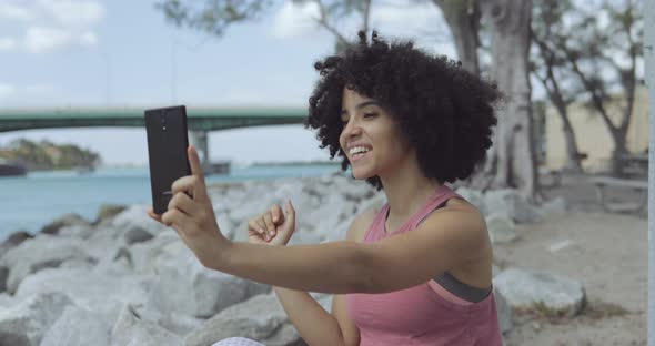 Cheerful Black Woman Taking Selfie on Seafront