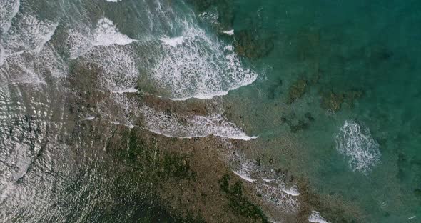 Top View of Waves Crashing on the Shore