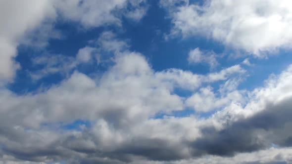 Timelapse of puffy cumulus clouds on a sunny day.