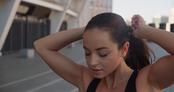 Portrait of Young Pretty Athletic Woman in Sportswear Standing Outdoors on Urban Background Smiling