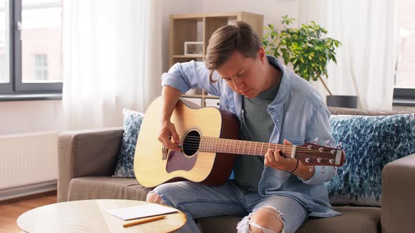 Young Man Playing Guitar at Home
