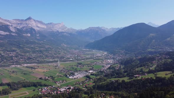 Aerial pan right fron a populated valley to a mountain range. Arve valley and Montblanc chain. Autum