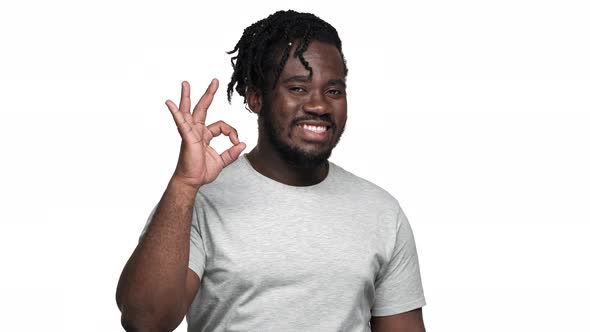 Portrait of Big African American Man Wearing Afro Hairdo and Mustache Gesturing Ok Sign at Camera