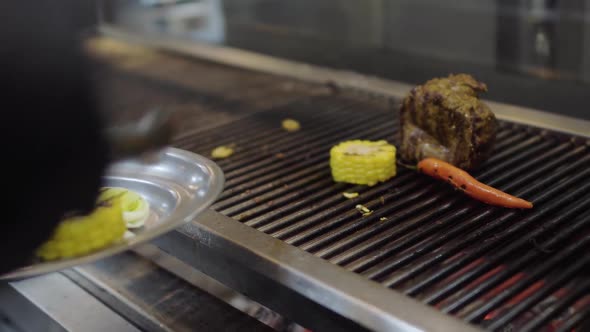 Professional Chef Cooking Vegetable on the Grill in the Restaurant Kitchen