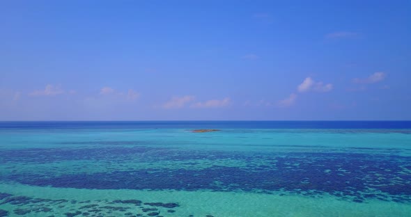 Daytime above clean view of a sunshine white sandy paradise beach and aqua blue water background 