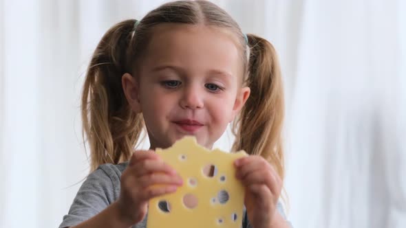 Funny Preschooler Girl Looks Through Yellow Cheese Holes