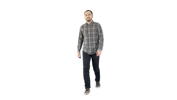 Smiling young man is walking on white background.