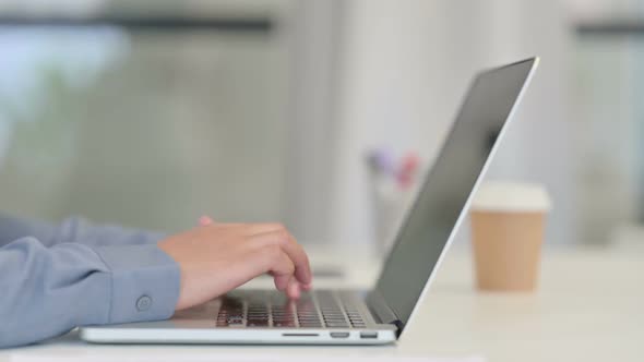 Close Up of African Woman Typing on Laptop