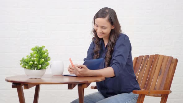 Attractive Indian girl writing something