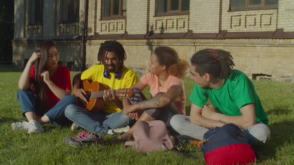 Multiracial Students with Guitar Resting at Campus