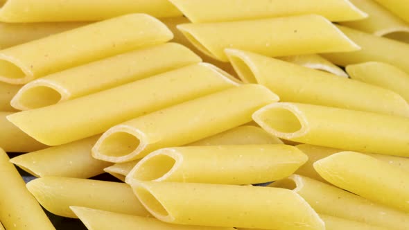 Macaroni penne, macro shot. Rotating motion shot, close up view from above in 4k.