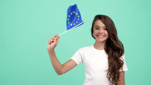 Amazed Child Waving European Union Flag on Blue Background Showing Thumb Up Eurozone