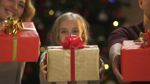 Cheerful Family Showing Presents at Camera, Christmas Preparation, Wishlist