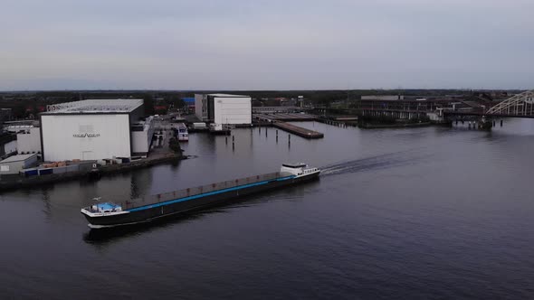 Freight Ship Sailing With Empty Cargo Holds At Noord River Near City Riverbanks In Netherlands. - Ae