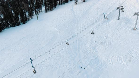 Elevator Cabins Move Over Snow Slope on Ski Resort Territory