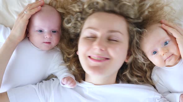 Young Mother And Her Babies Smiling At Camera, Happy Maternity Concept