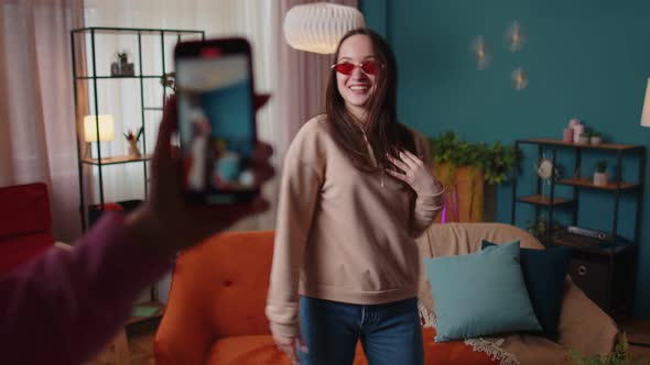 Joyful Blogger Teen Girl Dancing at Camera Filming Video Using Mobile Phone at Home in Living Room