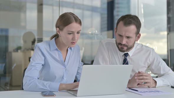 Business People Shocked While Working on Laptop 