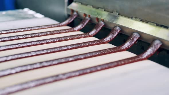 Rows of Sweet Paste Are Being Released Onto the Conveyor